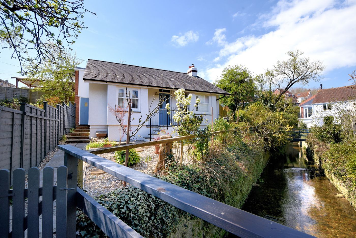 A house with a garden and a canal.