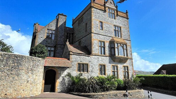 A stone castle with multiple towers and a large arched entrance. - 5 Coram Tower (Lyme Regis)