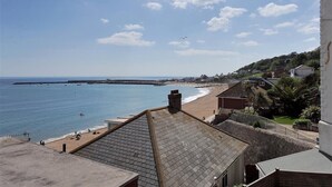 A coastal town with a beach, houses, and a pier. - Ross House (Lyme Regis)
