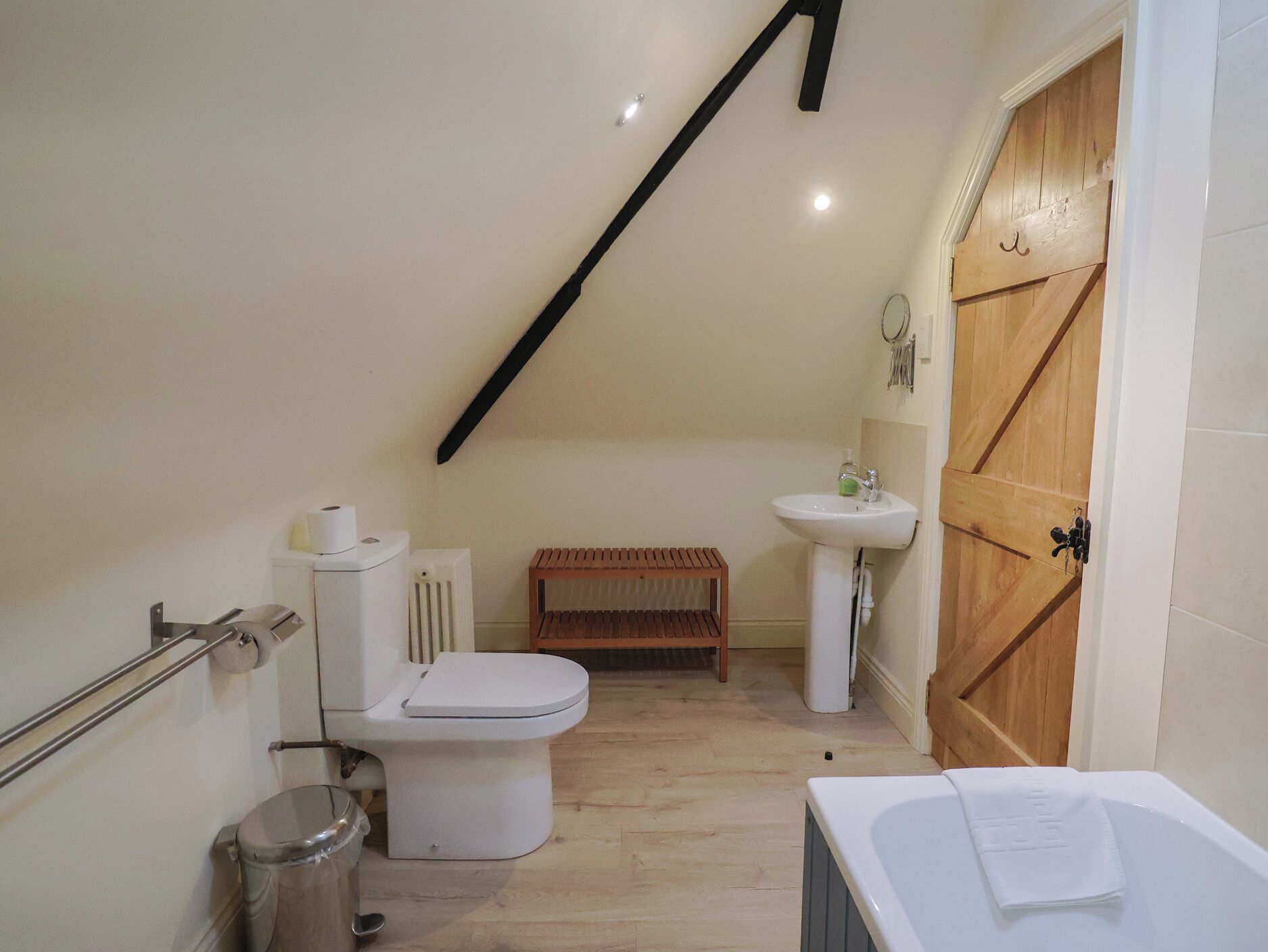 A small, compact bathroom with a toilet, sink, and bathtub.