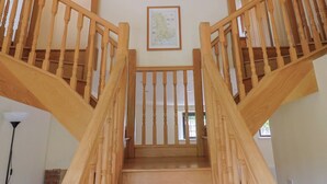 A wooden staircase with a framed map on the wall.