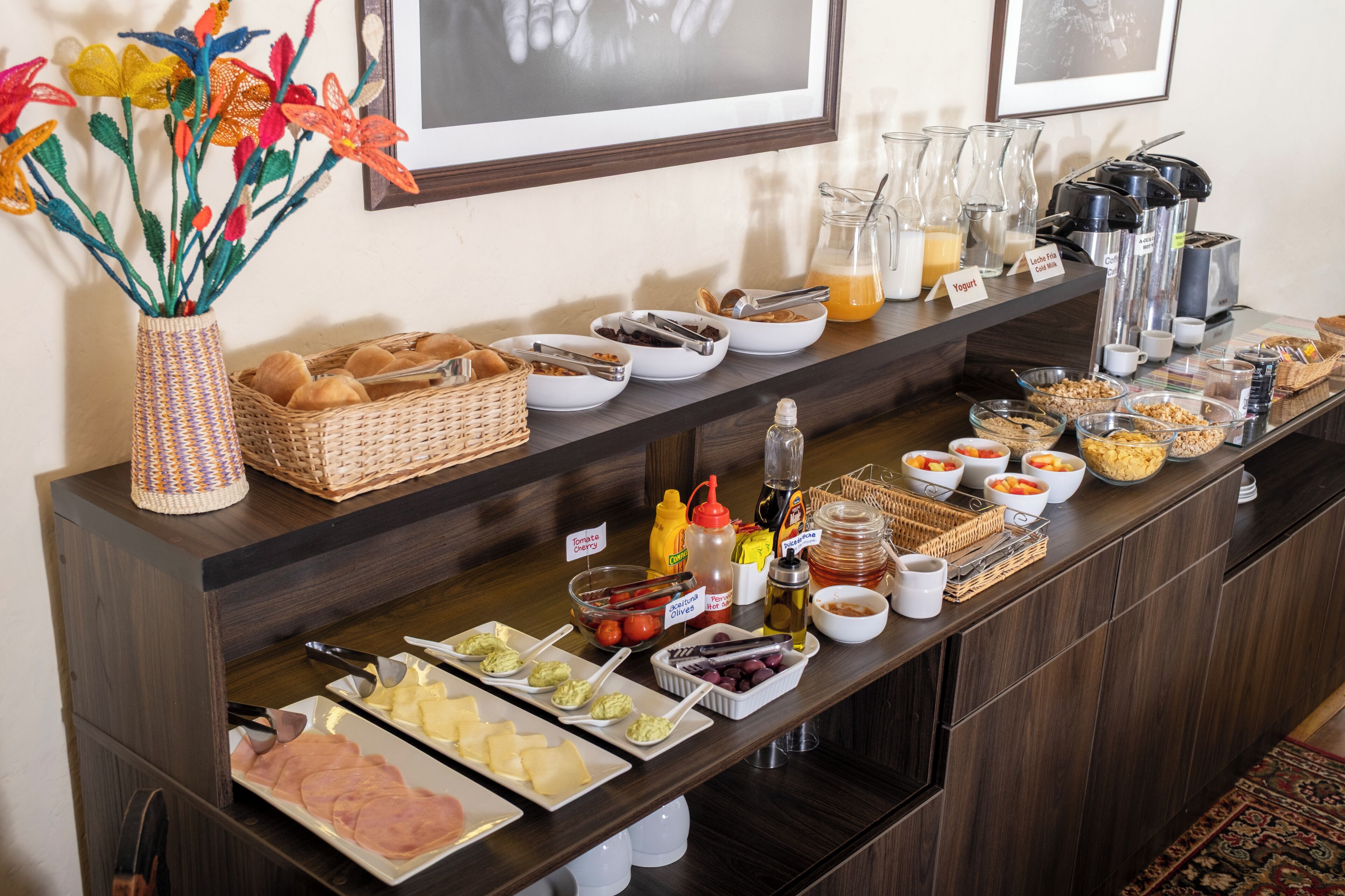 A buffet setup with various food items and condiments.