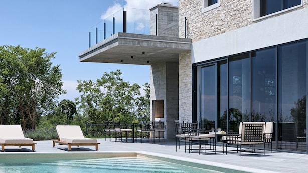 A modern outdoor pool area with lounge chairs and a dining setup. - Villa New Vintage with Pool (Pazin)