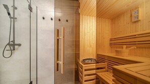A sauna with wooden benches and a glass partition separating the shower area. - Villa Maremonte with Pool (Kaštel Kambelovac)
