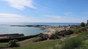 A coastal town with a beach, promenade, and residential buildings. - High Cliff Orchard (Lyme Regis)
