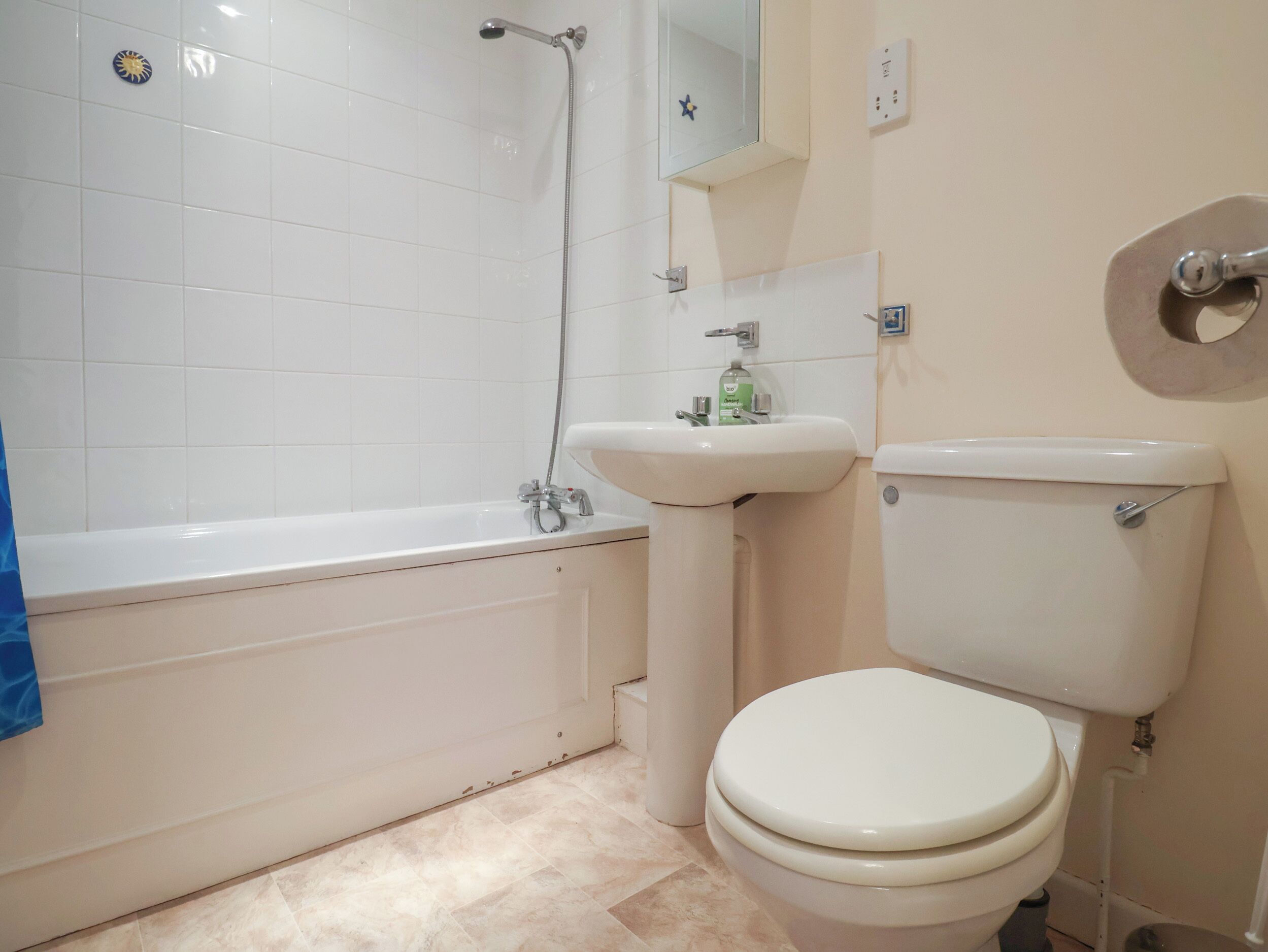 A bathroom with a bathtub, sink, and toilet.