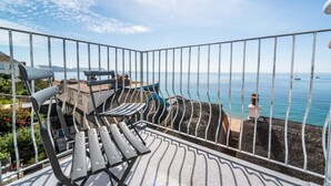 A balcony with metal railings, a bench, and a view of the sea. - 3 Beach Way House (Lyme Regis)