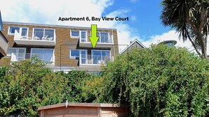 A multi-story residential building with balconies, labeled as Apartment 6, Bay View Court. - 6 Bay View Court (Lyme Regis)