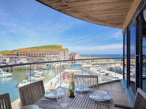 A table set for dining with a view of a marina and buildings in the background. - Venezuela (Bridport)