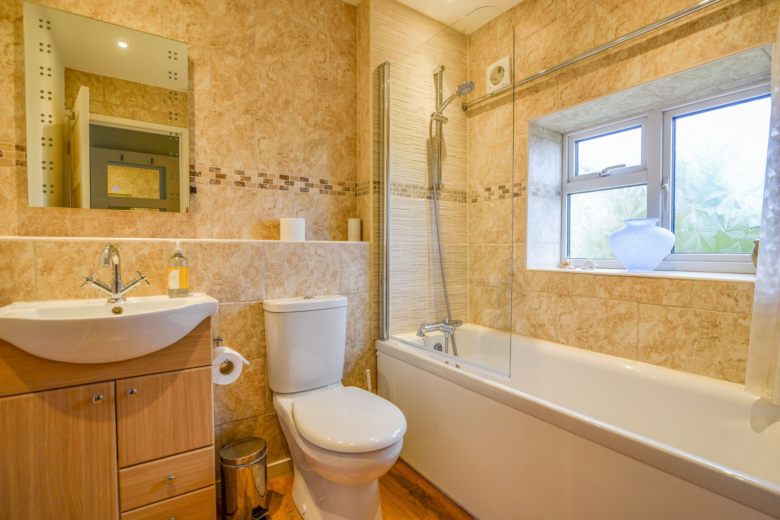 A bathroom with a sink, toilet, and bathtub.
