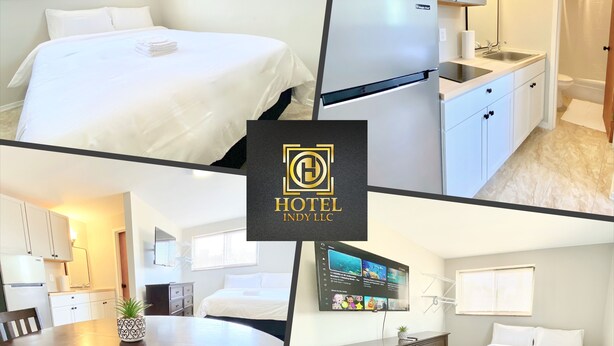 Une chambre d’hôtel comprenant un lit, une kitchenette, un coin repas et une salle de bain.