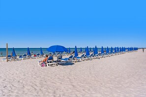 Relax on the beach with ocean views and comfortable lounge chairs.