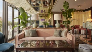 A spacious living area with a sofa, coffee table, and various plants. - Gleneagles Townhouse (Edinburgh)