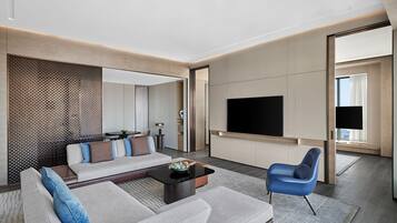 A modern living room with a sofa, a coffee table, and a TV.