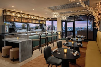 A Marriott hotel with a modern glass facade, a prominent entrance, and outdoor seating. at Washington Marriott Capitol Hill
