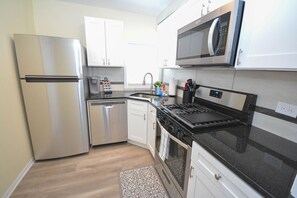 A modern kitchen with stainless steel appliances, a dishwasher, and a microwave. - Beautiful 2 BR apartment near Mayo Clinic Campus (Rochester)