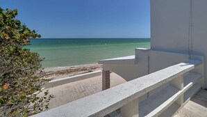 A balcony with a view of the sea and a white building. - Casa Mega - Yucatan Home Rentals (Chicxulub Puerto)