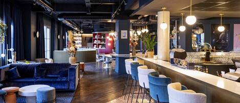 Un espace bar moderne comprenant un comptoir, des sièges et un assortiment de tabourets et de chaises de bar.