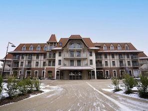 A large, multi-story hotel with a symmetrical facade, multiple balconies, and a central entrance.