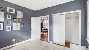 A room with grey walls, a white door, and a white ceiling. There are framed pictures on the wall and a white floor lamp. - 5⭐️BEST PRICE⭐️ Whole apt.3 bdrm for 2-8, long term (Providence)