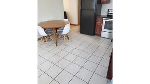 A kitchen with a dining table, chairs, a refrigerator, and an oven. - 5⭐️BEST PRICE⭐️Robert's 3 Room for 2-7ppl Long term (Providence)