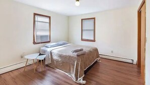 A bedroom with a bed, a small table, two windows, and a door. - 5⭐️BEST PRICE⭐️Robert's 3 Room for 2-7ppl Long term (Providence)