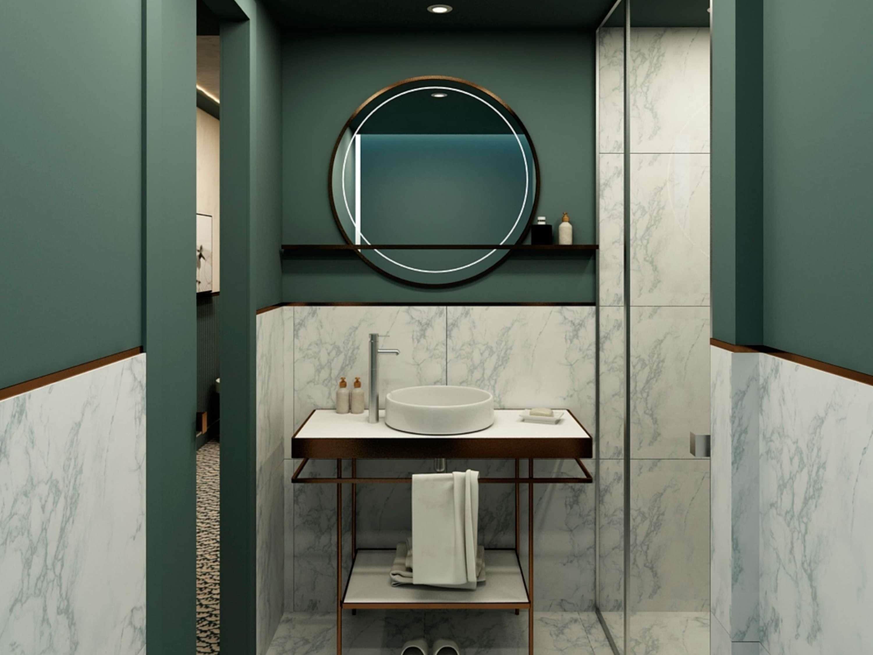 Ein modernes Badezimmer mit rundem Spiegel, Marmorwänden, einem Waschbecken mit Handtuchhalter und einem Ablagebereich für Toilettenartikel.