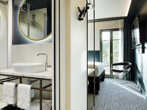 A modern bathroom with a large mirror, a sink, and a shower. - Tribe Le Touquet (Le Touquet-Paris-Plage)