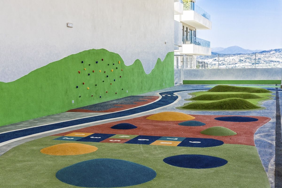 A colorful play area with climbing walls and soft play surfaces.