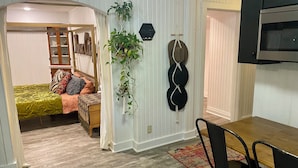 A compact living space with a bed, a dining area, and a kitchen. - Sweet little apartment with hot tub,gazebo,and an acre backyard! Walkable area! (Nashville)