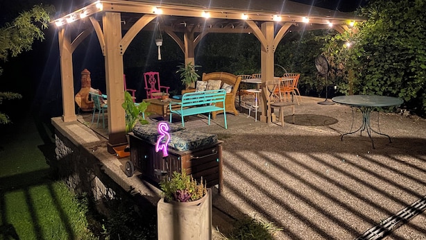 An outdoor patio with a wooden pergola, seating arrangements, and a small table. - Sweet little apartment with hot tub,gazebo,and an acre backyard! Walkable area! (Nashville)