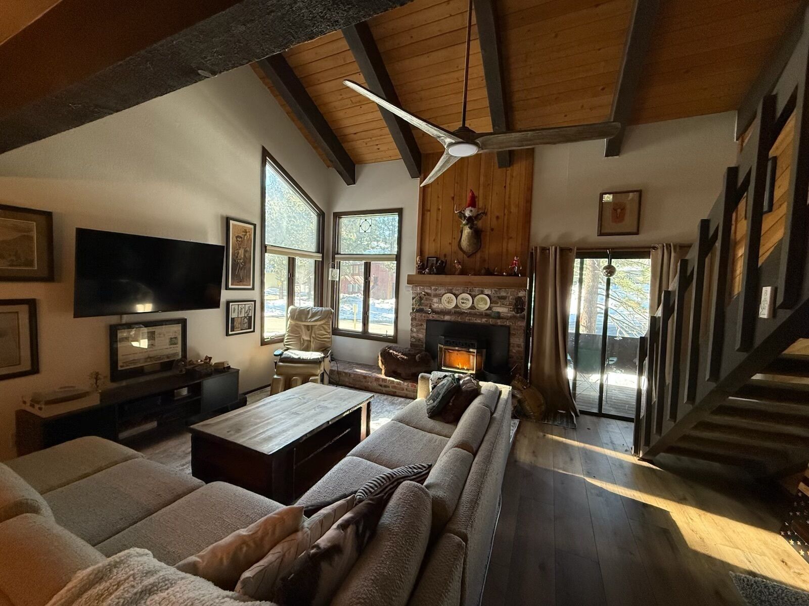 A cozy living room with a fireplace, a large TV, and a comfortable seating area.