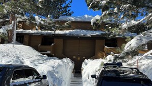 A snow-covered driveway leading to a wooden building with a garage. - Perfect Family & Dog Friendly 2 Story Condo, Sleeps 8+, 1 Mile To Village,  #66 (Mammoth Lakes)
