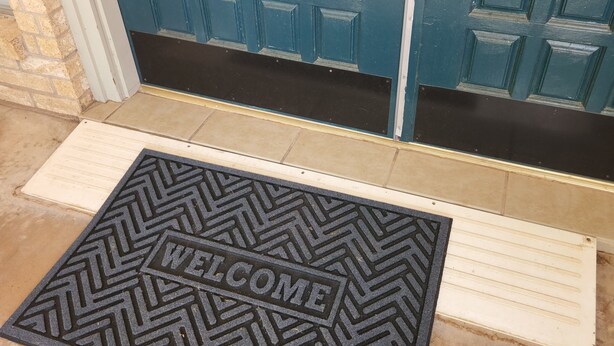 A blue door with a doormat that reads "WELCOME". - Single Family Home 3 bedroom 2 bath (San Angelo)