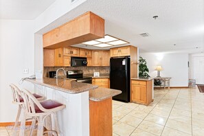 Enjoy meals in the kitchen with a central island, microwave, and refrigerator.