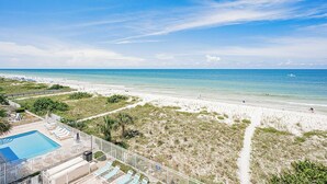 A beach view with a swimming pool and lounge chairs. - Direct GULF front Condo - Oceanway 403 (Indian Rocks Beach)