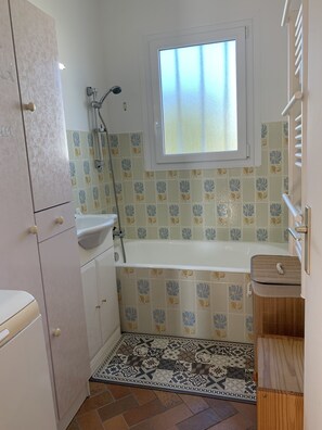Bathtub, hair dryer, towels, soap