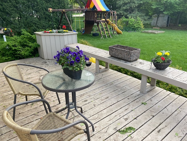 Enjoy a peaceful moment on the deck with a potted plant and comfortable seating.