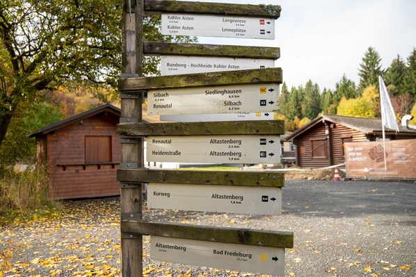 A wooden directional signpost with multiple route indications.