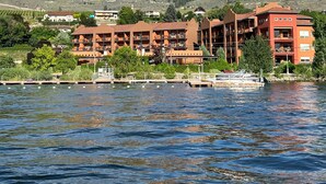A hotel with multiple buildings, a dock, and a lake. - Lakeshore Villas Resort - Three Bedroom Lakefront Condo  (Osoyoos)