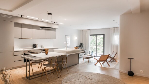 A modern kitchen with a central island, wooden chairs, and a large window providing natural light. - Marvelous 2BR Apartment with balcony  B (Athens)