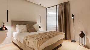 A modern bedroom with a large bed, a bedside table with a vase, and a floor lamp. - Marvelous 2BR Apartment with balcony  B (Athens)