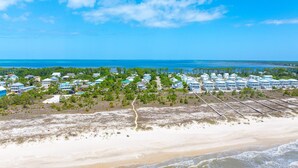 A coastal resort with beachfront properties, a sandy beach, and a clear view of the ocean. - Boardwalk Sandpiper (Port St. Joe)