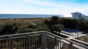 A coastal property with a wooden deck, a pool, and a view of the ocean. - Gulfside GEM (Port St. Joe)