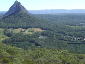 Surrounded by lush greenery and majestic mountains, this serene landscape offers a peaceful retreat.