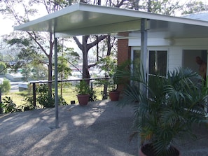 Relax in a serene outdoor space surrounded by lush greenery and a brick wall.