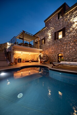 A stone building with a pool, outdoor seating, and a staircase leading to a balcony. - Stunning Villa on Island Krk Near Sandy Beach (Vrbnik)