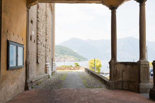 A corridor with a view of a lake and mountains.