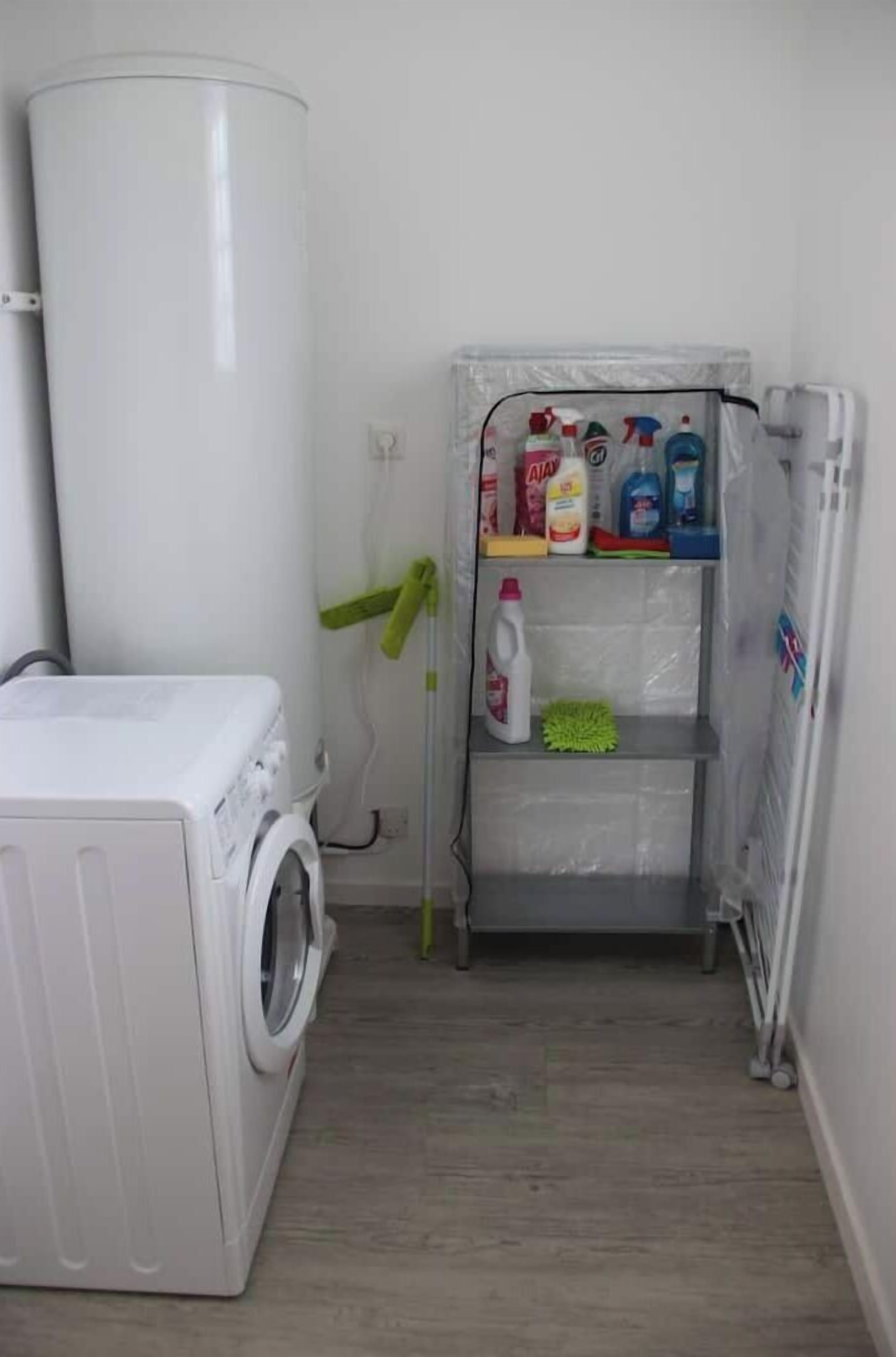 A laundry area with a washing machine, a shelf with cleaning supplies, and a radiator.