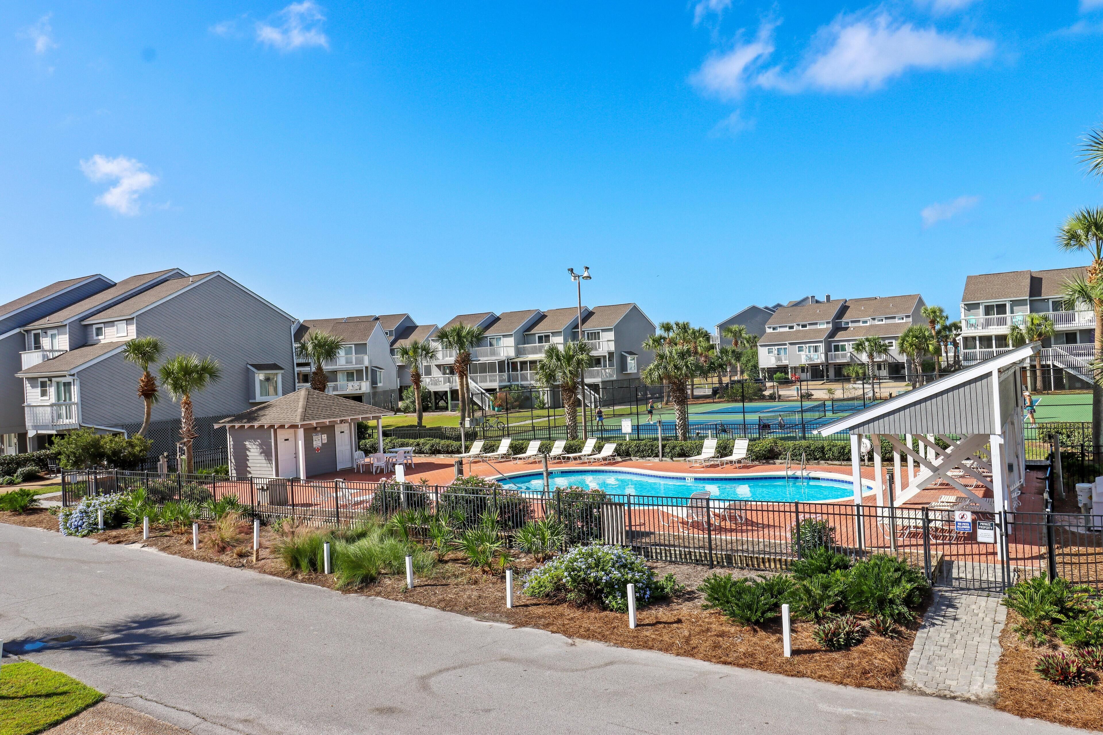 Un quartier résidentiel avec une piscine, des maisons et une rue.